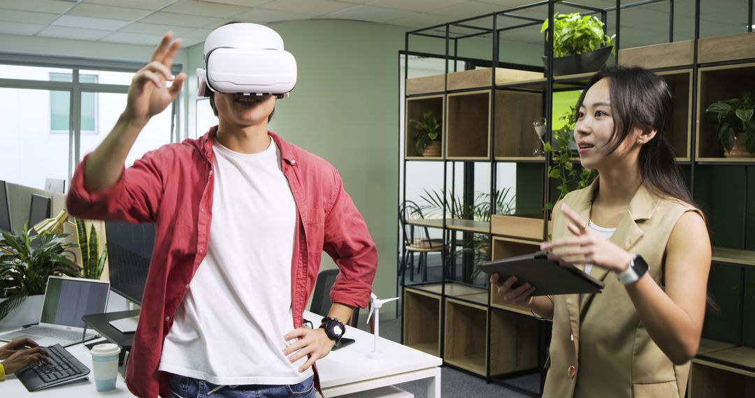 Coworkers Demonstrating Virtual Reality in Modern Office