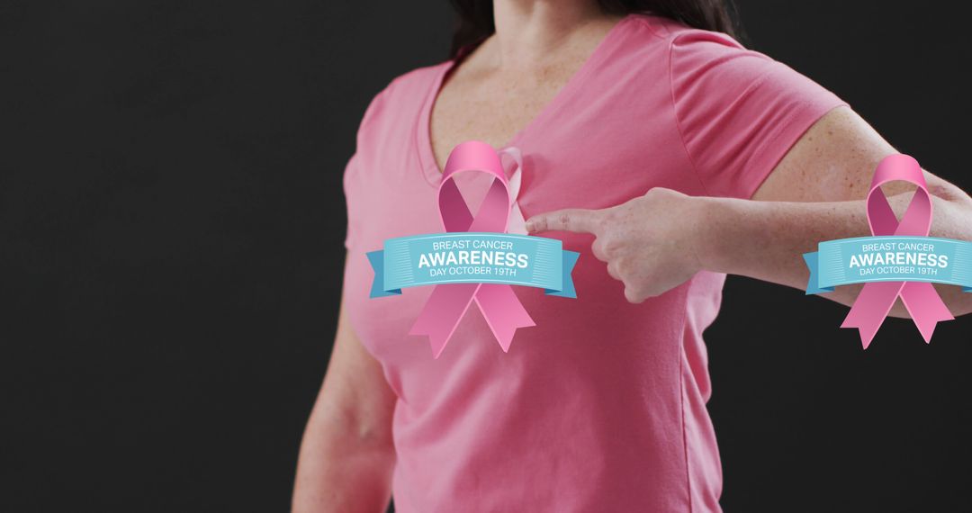 Woman Wearing Pink Shirt Pointing at Breast Cancer Awareness Ribbon - Free Images, Stock Photos and Pictures on Pikwizard.com