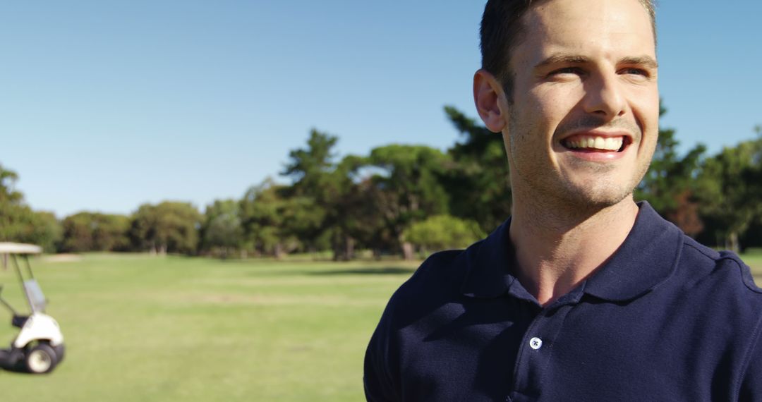 Smiling man enjoying sunny day on golf course - Free Images, Stock Photos and Pictures on Pikwizard.com