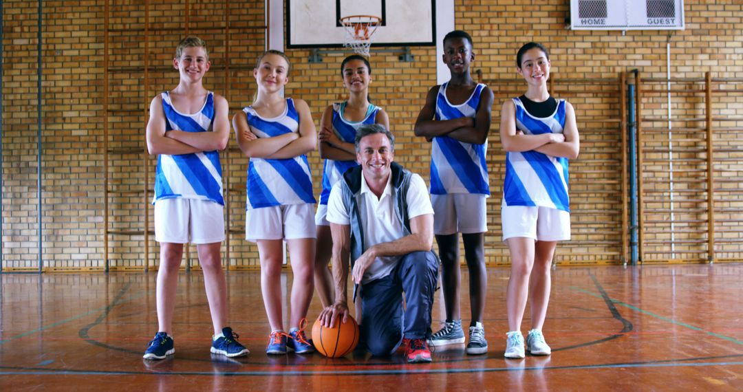 Basketball Coach with Smiling Youth Team in Gymnasium - Free Images, Stock Photos and Pictures on Pikwizard.com