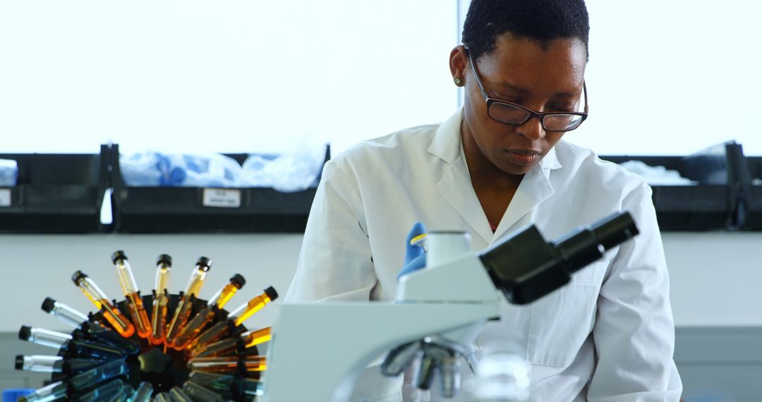 Scientist Conducting Research in Laboratory with Microscope and Test Tubes - Free Images, Stock Photos and Pictures on Pikwizard.com