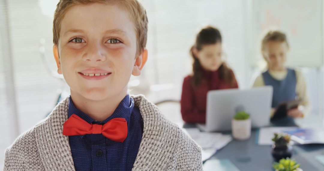 A young Caucasian boy in a bow tie smiles confidently at the camera, with copy space - Free Images, Stock Photos and Pictures on Pikwizard.com