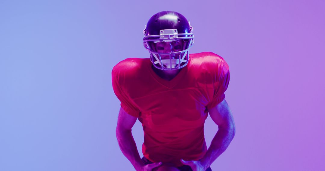 Image of caucasian american football player in helmet with ball over neon purple background - Free Images, Stock Photos and Pictures on Pikwizard.com