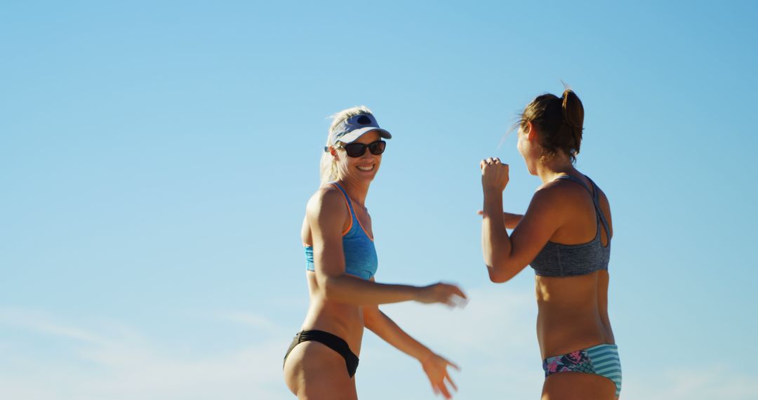 Two Women Enjoying Conversation on Sunny Beach - Free Images, Stock Photos and Pictures on Pikwizard.com