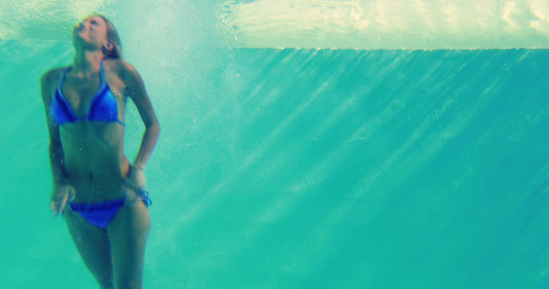 Woman Swimming Underwater Wearing Blue Bikini - Free Images, Stock Photos and Pictures on Pikwizard.com