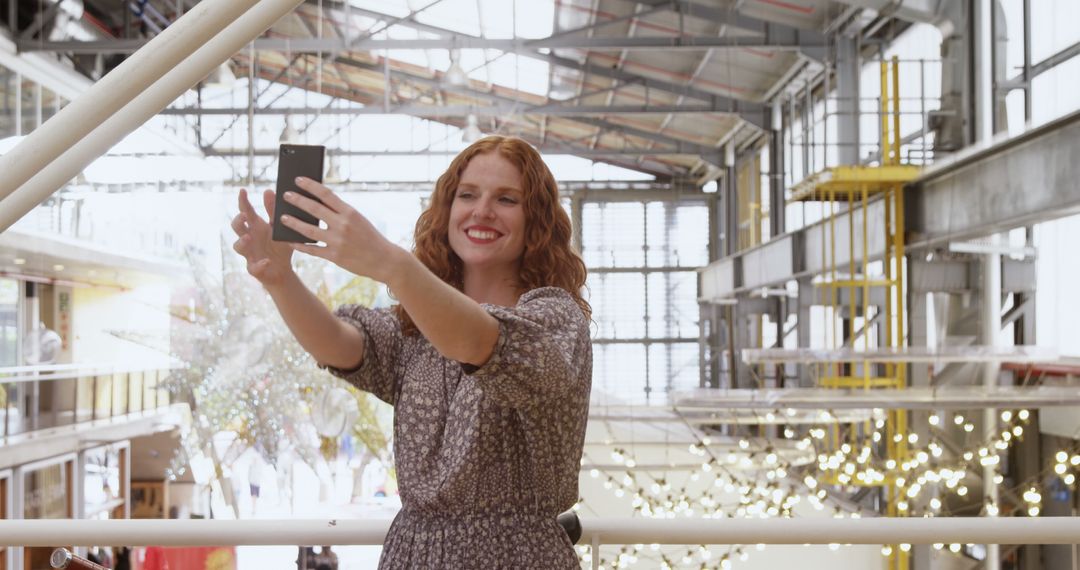 Happy Woman Taking Selfie in Modern Indoor Space - Free Images, Stock Photos and Pictures on Pikwizard.com