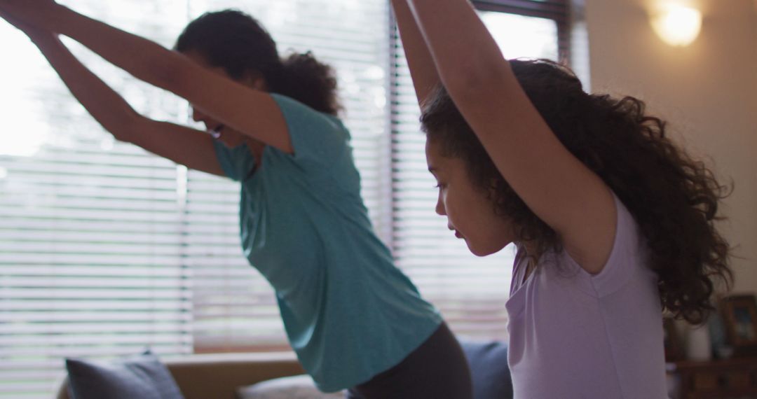 Mother and Daughter Practicing Yoga Together Indoors - Free Images, Stock Photos and Pictures on Pikwizard.com