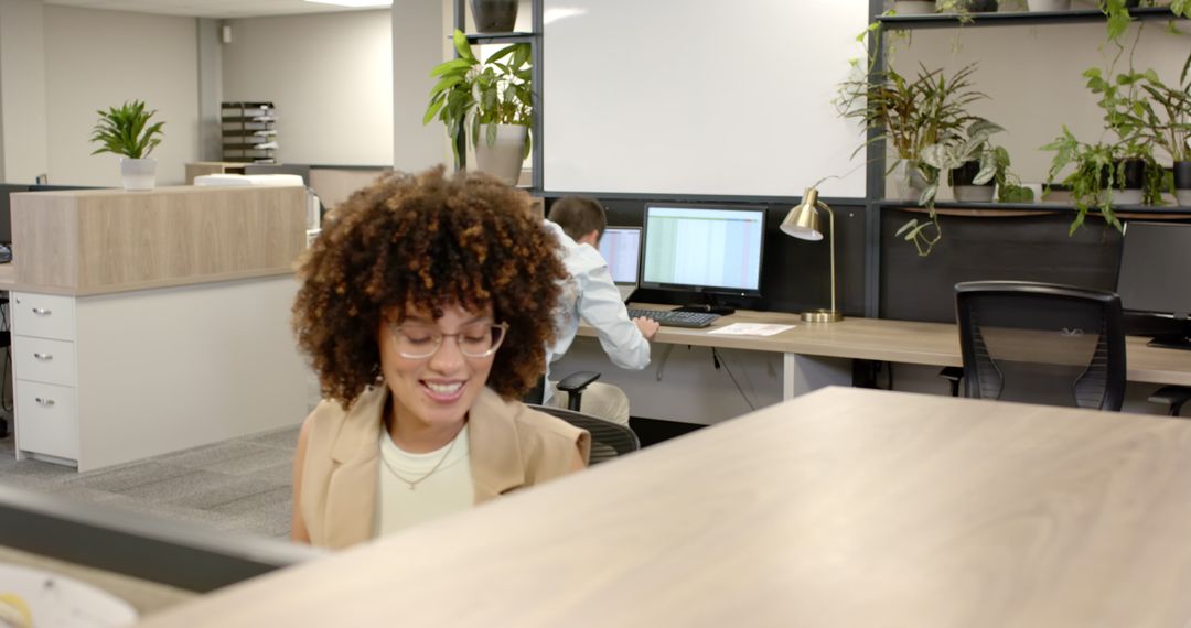 Smiling Coworker in Modern Office with Greenery