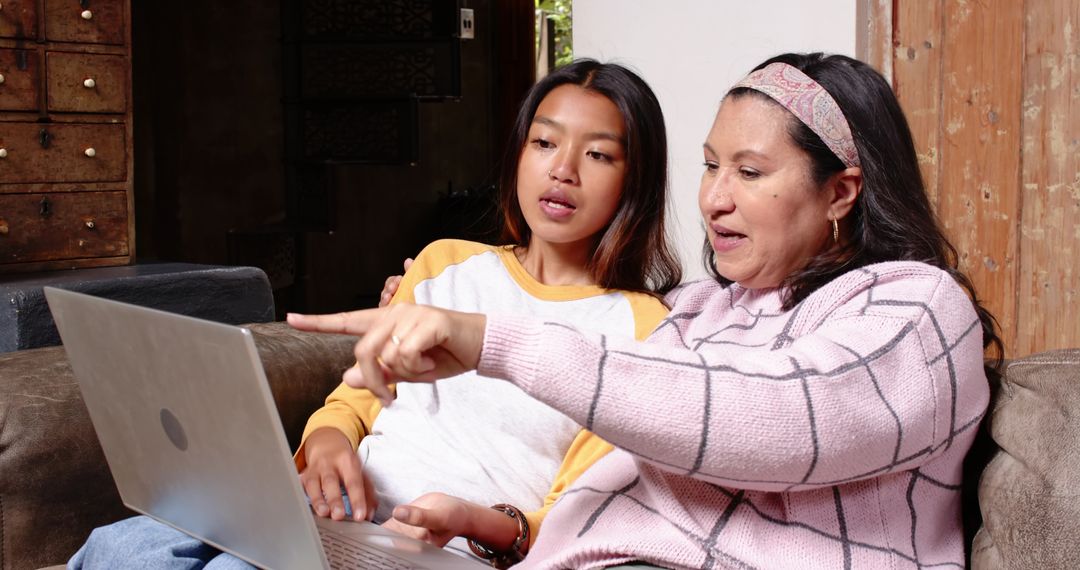 Female Mentor and Student Collaborating Using Laptop on Couch