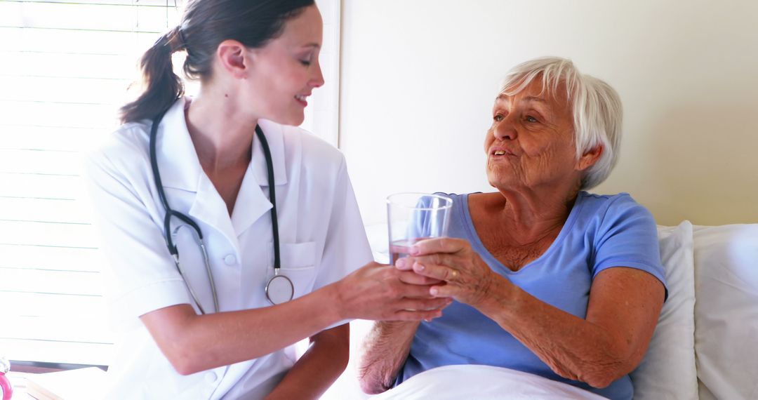 Nurse Assisting Elderly Woman with Glass of Water - Free Images, Stock Photos and Pictures on Pikwizard.com