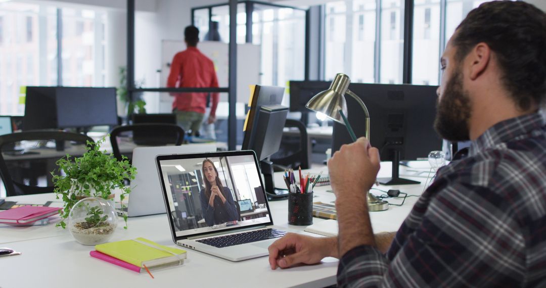 Middle Eastern Man Video Conferencing with Colleague in Modern Office
