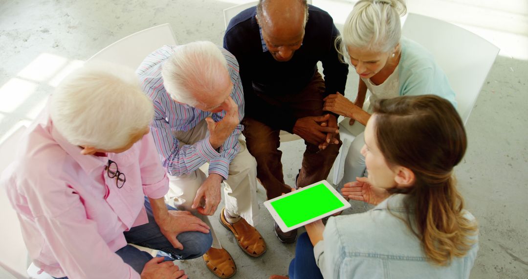 Senior Adults Engaged in Learning Session with Tablet Technology