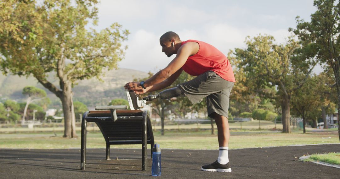 Athletic Man Stretching Outdoors on a Park Bench for Warm-up - Free Images, Stock Photos and Pictures on Pikwizard.com