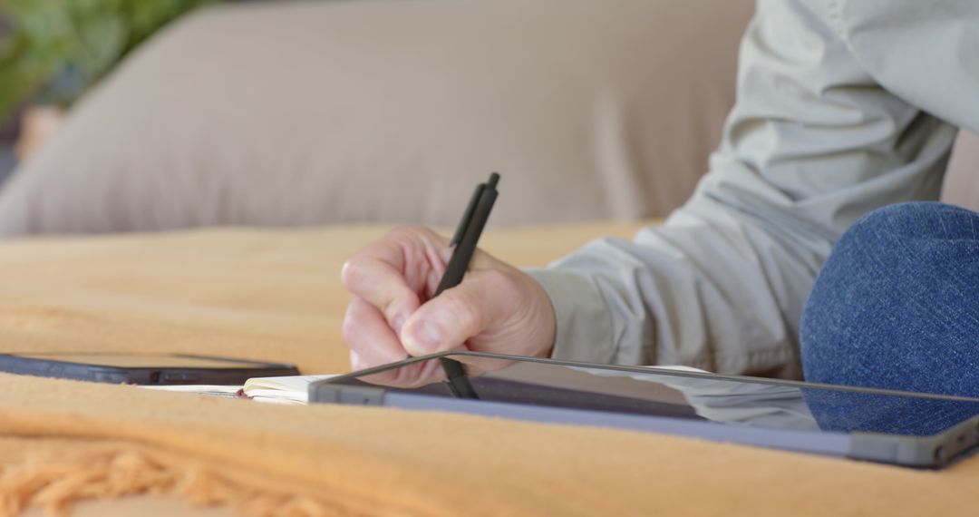 Digital Artist Drawing on Tablet Relaxing on Couch