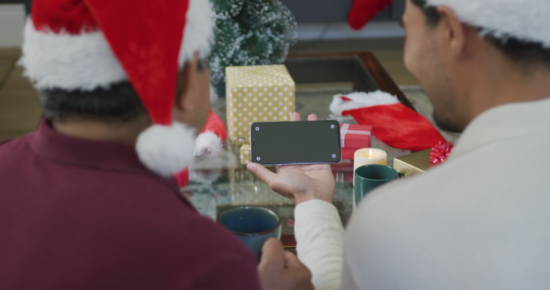 Couple Celebrating Christmas Showing Smartphone Screen - Free Images, Stock Photos and Pictures on Pikwizard.com