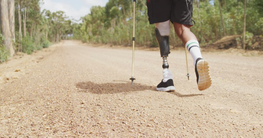 Determined Person Jogging with Prosthetic Leg on Rural Path - Free Images, Stock Photos and Pictures on Pikwizard.com