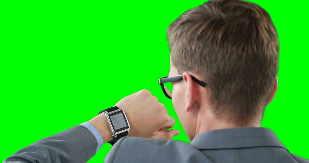 Businessman Analyzing Smartwatch Against Green Screen