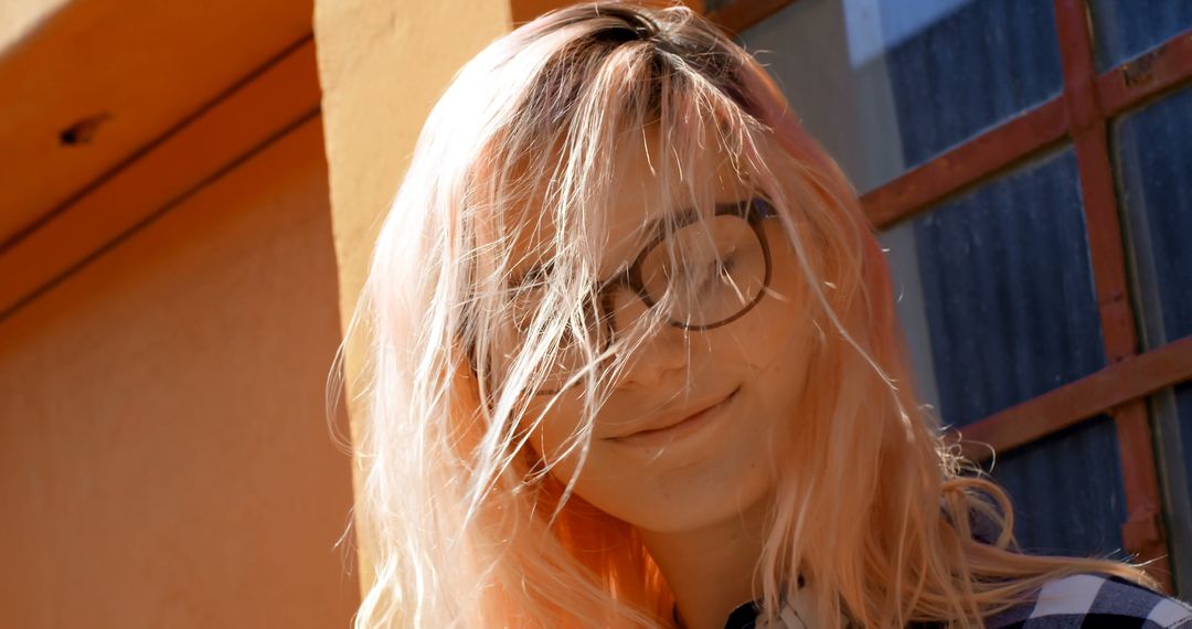 Young Woman with Pink Hair and Glasses Smiling in Sunlight - Free Images, Stock Photos and Pictures on Pikwizard.com