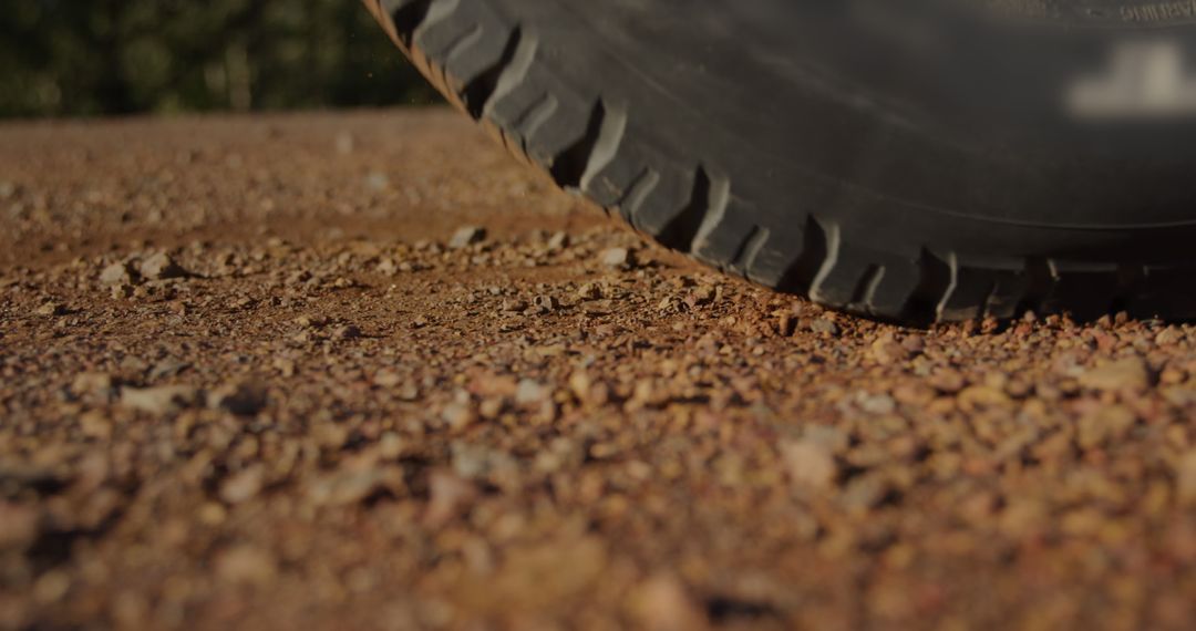 Car Tire on Gravel Road on Sunny Day - Free Images, Stock Photos and Pictures on Pikwizard.com