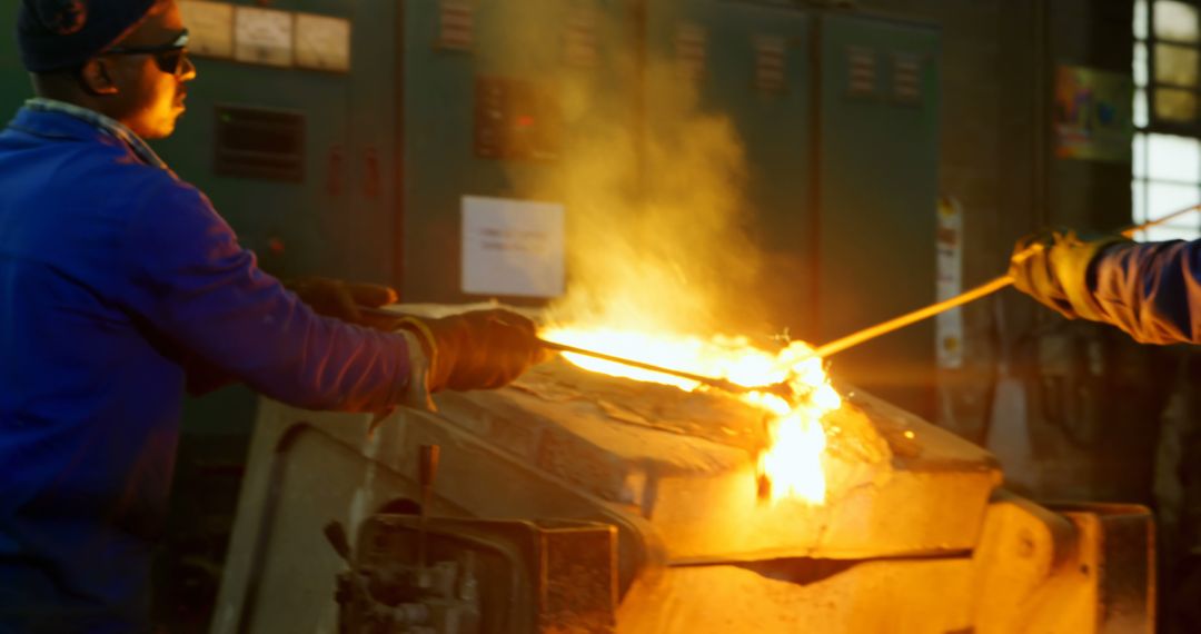 Workers Managing Molten Metal in Industrial Foundry - Free Images, Stock Photos and Pictures on Pikwizard.com