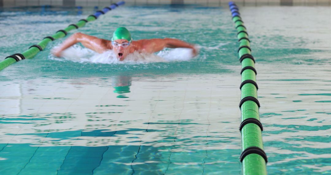 Competitive Swimmer Performing Breaststroke in Indoor Pool - Free Images, Stock Photos and Pictures on Pikwizard.com