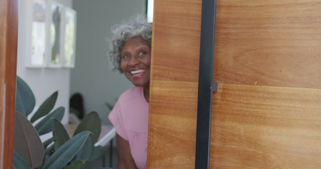 Portrait of happy senior african american woman opening door at retirement home - Free Images, Stock Photos and Pictures on Pikwizard.com