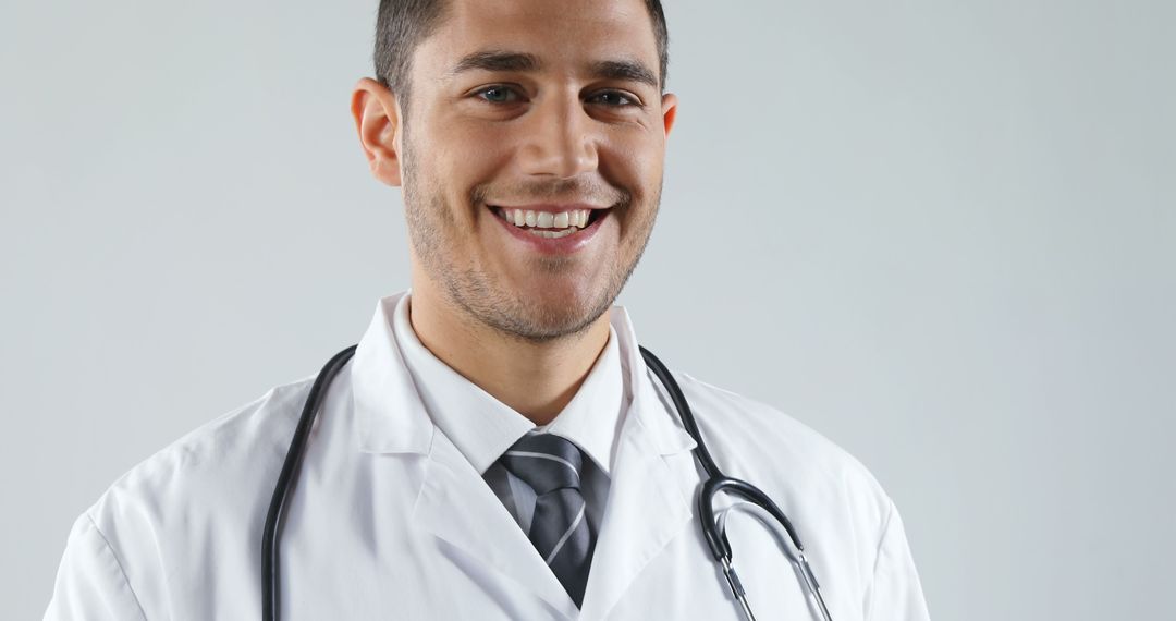 Smiling Male Doctor in White Lab Coat with Stethoscope - Free Images, Stock Photos and Pictures on Pikwizard.com