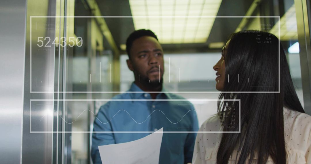 Coworkers Collaborating in Elevator with Digital Interface