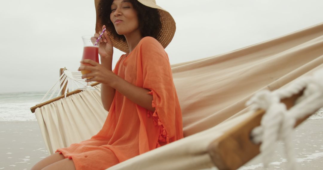 Woman Relaxing on Beach Hammock with Tropical Drink - Free Images, Stock Photos and Pictures on Pikwizard.com