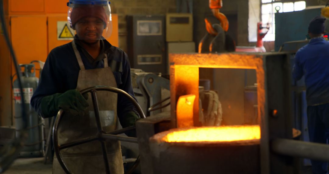 Steel Worker Operating Liqiud Metal Furnace in Industrial Foundry - Free Images, Stock Photos and Pictures on Pikwizard.com