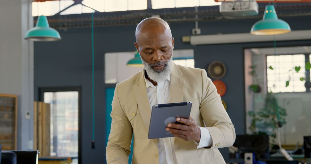 Mature businessman using tablet in modern office - Free Images, Stock Photos and Pictures on Pikwizard.com