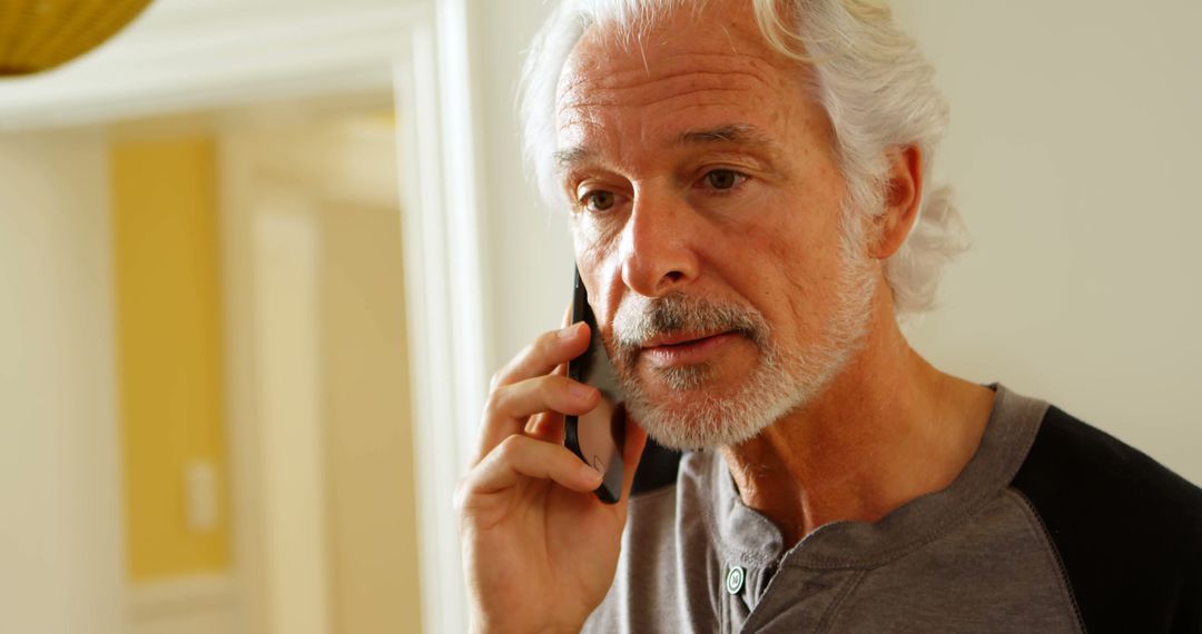 Senior Man with Gray Hair Talking on Smartphone at Home - Free Images, Stock Photos and Pictures on Pikwizard.com