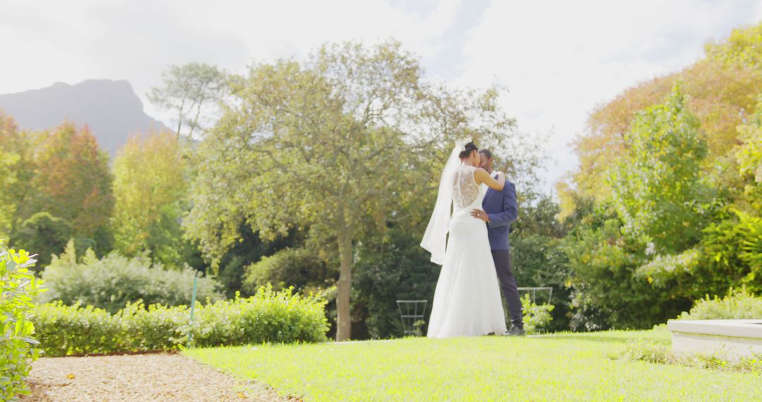 Newlywed Couple Embracing in Lush Garden Setting