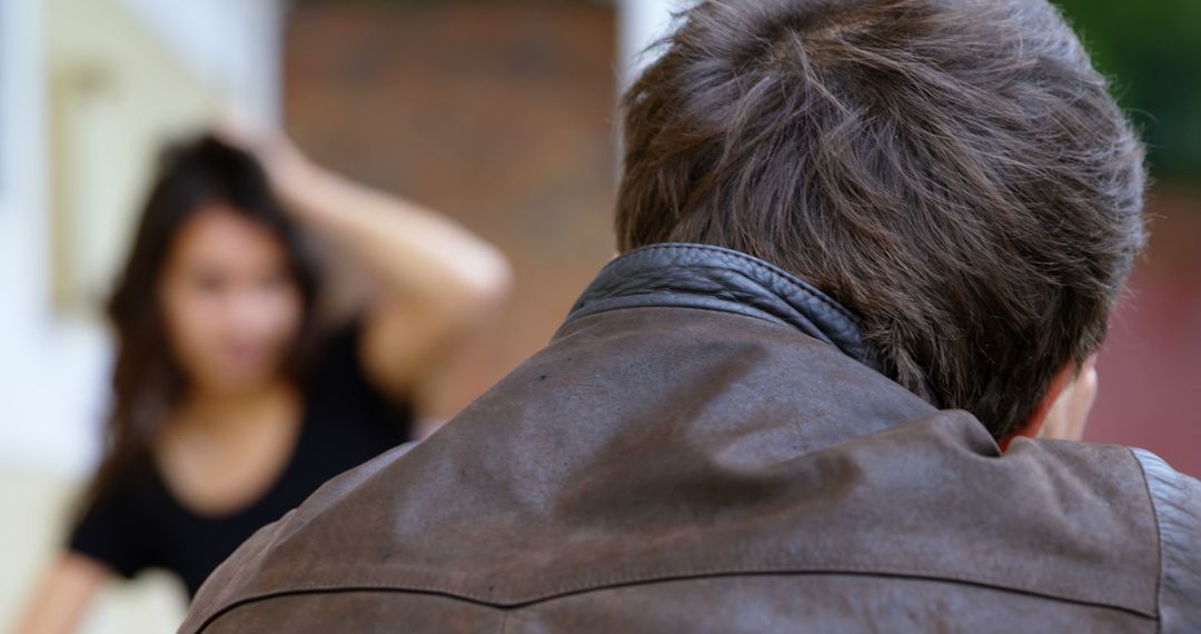 Man Focusing on Blurred Woman in Background - Free Images, Stock Photos and Pictures on Pikwizard.com