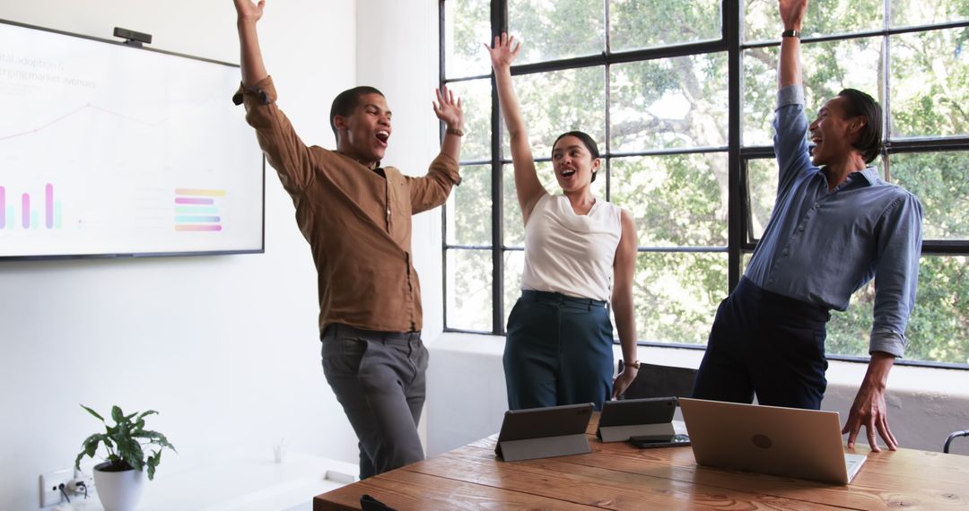 Happy Diverse Team Celebrating Successful Office Presentation