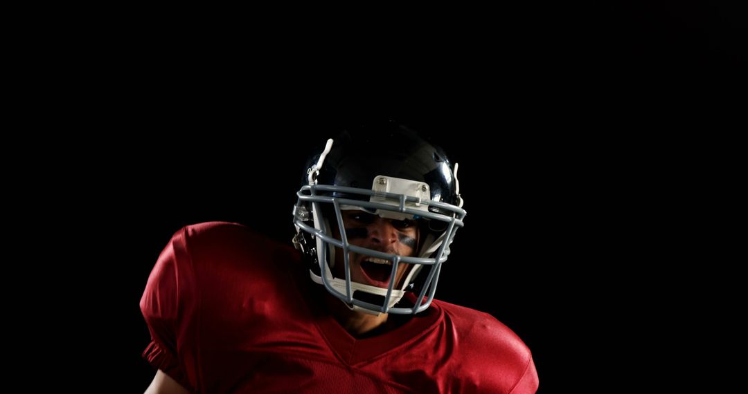 Intense Football Player Shouting in Red Jersey and Helmet - Free Images, Stock Photos and Pictures on Pikwizard.com
