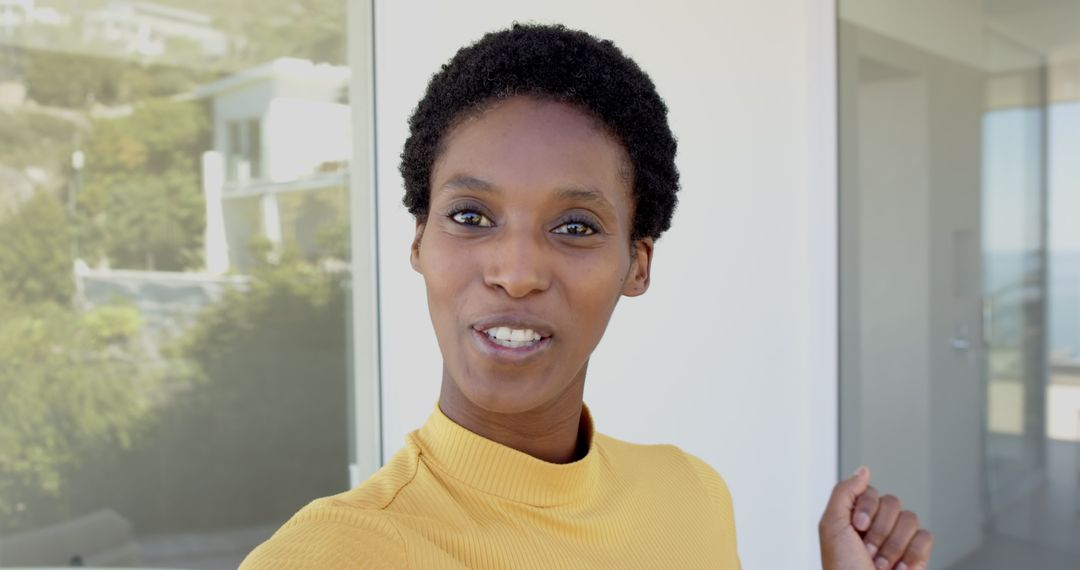 Joyful African American Woman Greeting by Modern Home