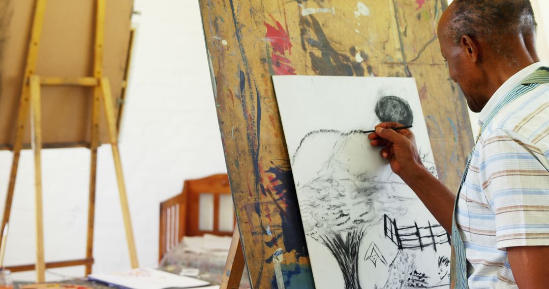 African-American Man Drawing on Canvas in Art Studio - Free Images, Stock Photos and Pictures on Pikwizard.com