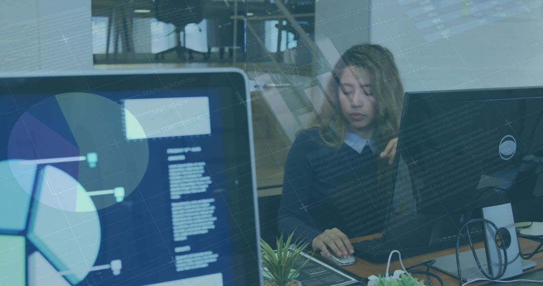Businesswoman Analyzing Data on Computer with Graphs Overlay