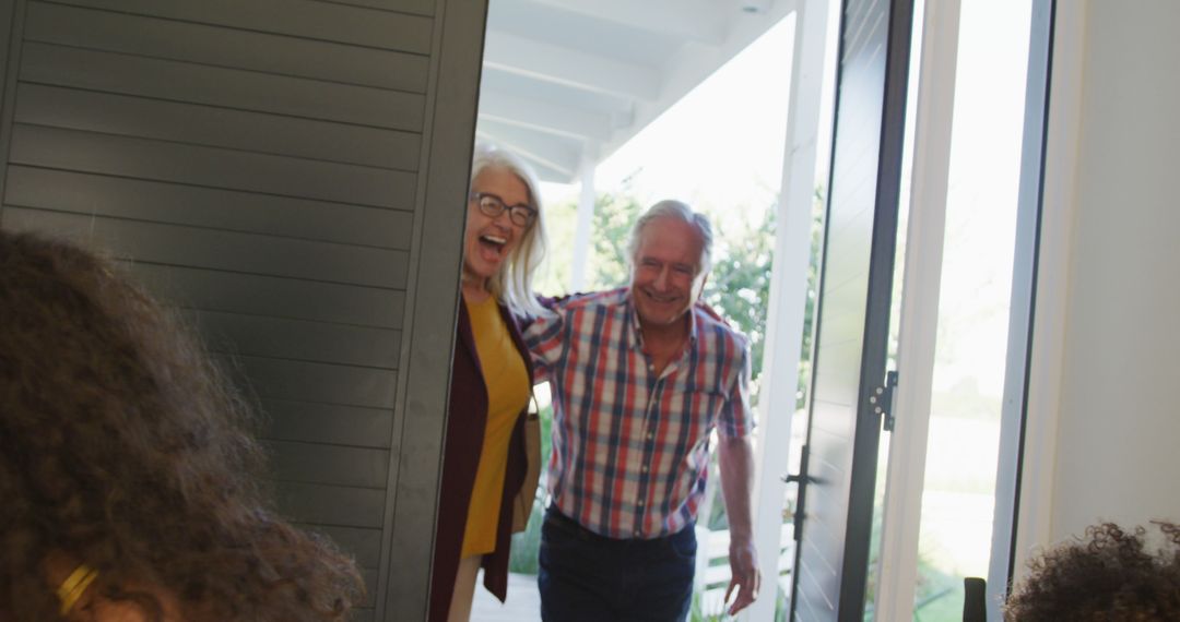 Image of happy caucasian grandparents welcomed at front door by diverse grandson and granddaughter - Free Images, Stock Photos and Pictures on Pikwizard.com