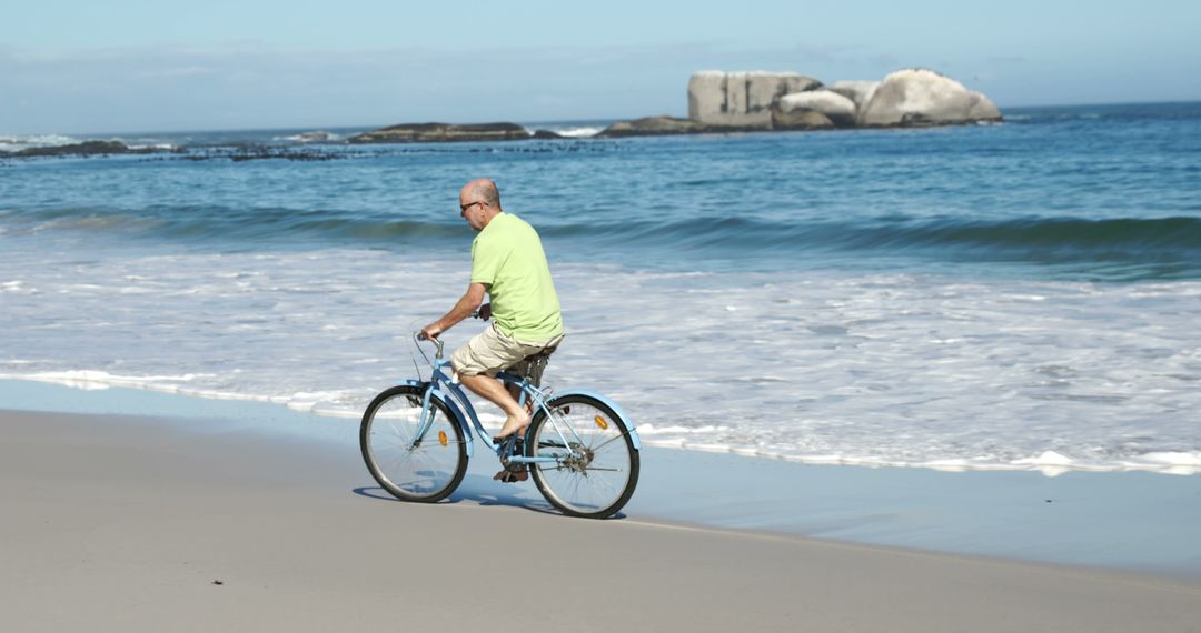 Senior Man Biking on Beach by the Ocean - Free Images, Stock Photos and Pictures on Pikwizard.com