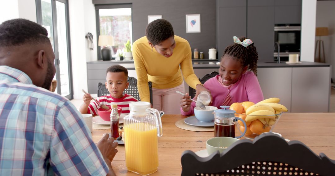 Happy African American Family Eating Breakfast Together in Modern Kitchen - Free Images, Stock Photos and Pictures on Pikwizard.com