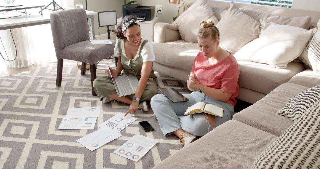 Home-Based Female Colleagues Analyzing Charts for Teamwork