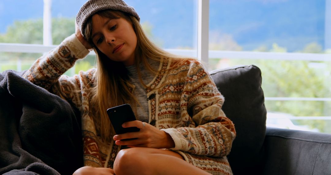 Woman Relaxing on Couch with Phone, Casual Look - Free Images, Stock Photos and Pictures on Pikwizard.com