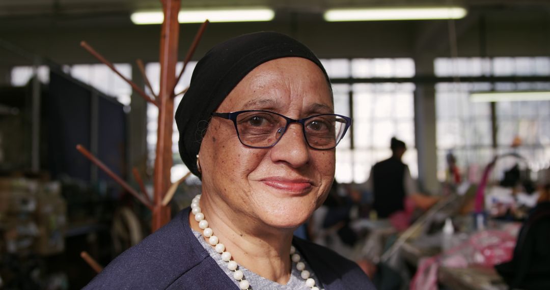 Elderly Woman Smiling Indoors Wearing Glasses and Pearl Necklace - Free Images, Stock Photos and Pictures on Pikwizard.com