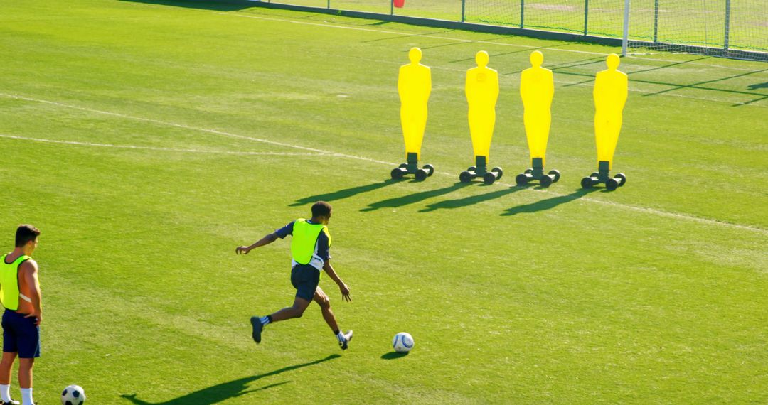 Soccer Players Practicing with Training Dummies on Field - Free Images, Stock Photos and Pictures on Pikwizard.com
