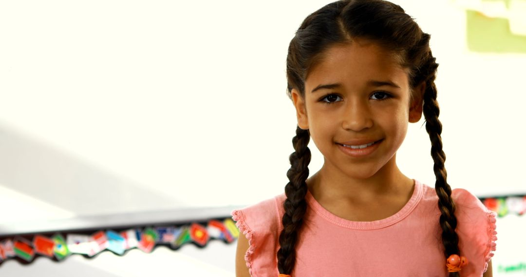 Smiling Girl with Braided Hair in Classroom - Free Images, Stock Photos and Pictures on Pikwizard.com