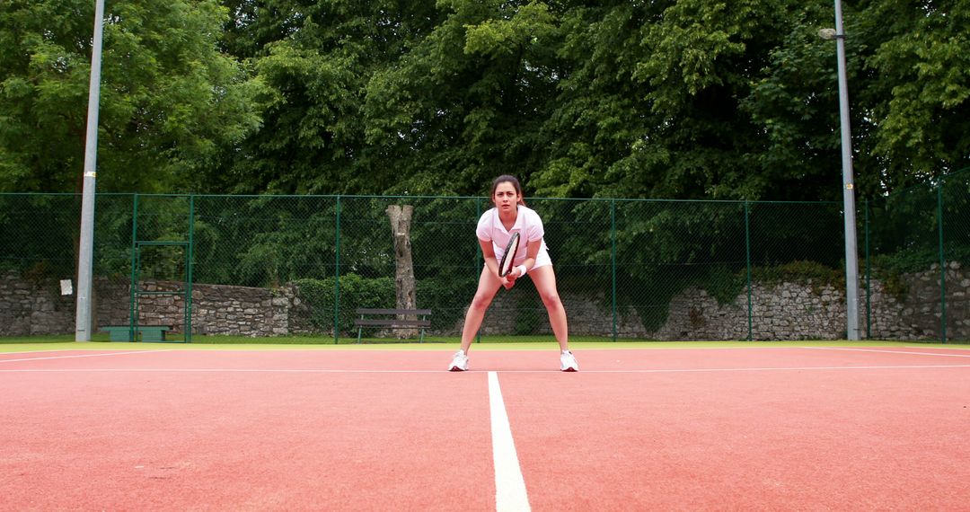 Female Tennis Player Positioned for Return on Court - Free Images, Stock Photos and Pictures on Pikwizard.com