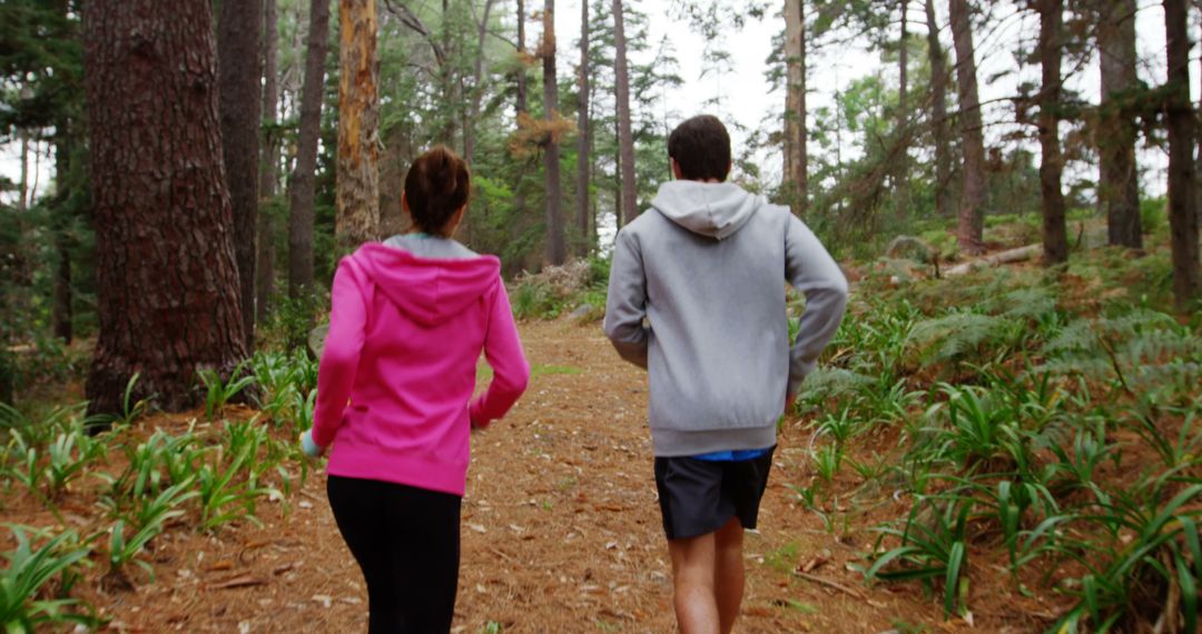 Couple Jogging Through Forest Path in Autumn - Free Images, Stock Photos and Pictures on Pikwizard.com