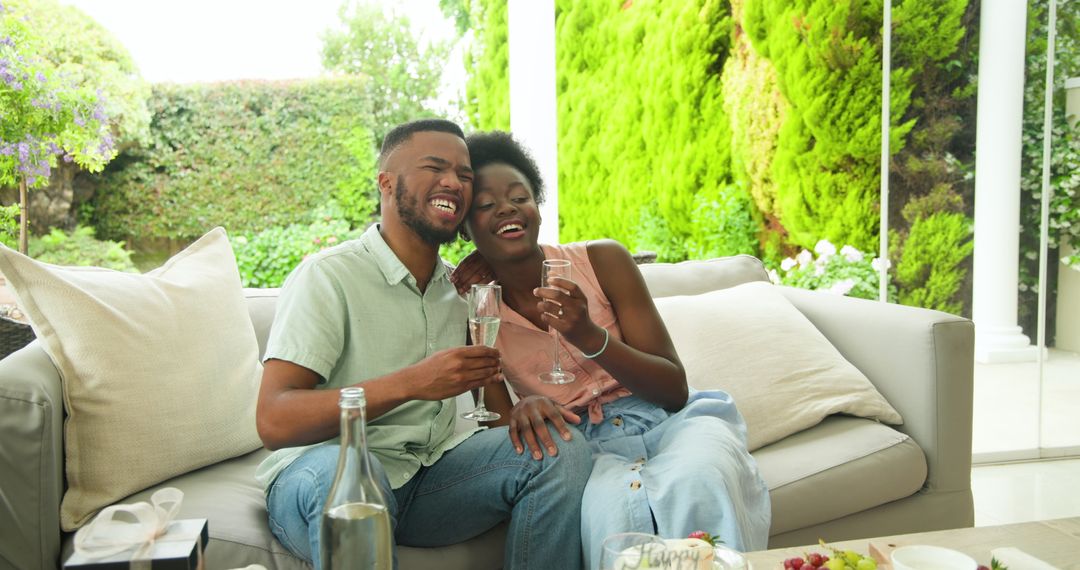 Joyful Couple Toasting on Modern Patio in Summer